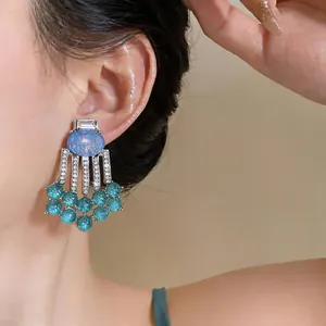 Close-up of vintage resin tassel earrings with sparkling rhinestones on model