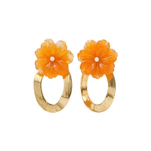 Elegant orange resin flower earrings with gold textured oval hoops and pearl centers