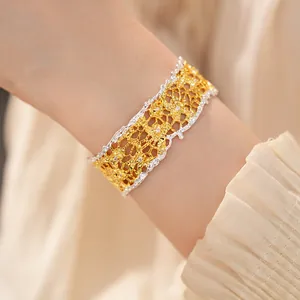 Macro view of French vintage lace filigree bracelet with gold and silver tones