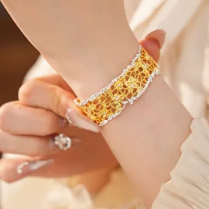 Detailed view of French vintage hollow lace-edge bracelet with gold and silver dual tones