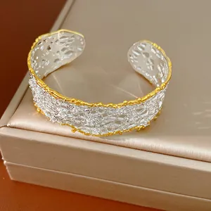 Detailed view of a French retro hollow lace-edged cuff bracelet featuring silver and gold tones