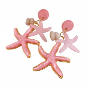 Elegant pink resin starfish drop earrings with gold trim for trendy beach vacation style.