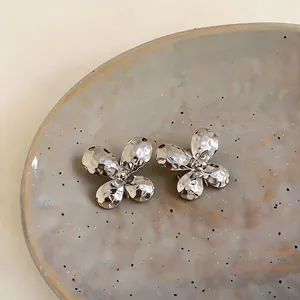 High-end hammered silver butterfly stud earrings with a light luxury metallic finish