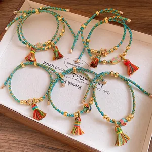 Handmade braided colorful cord bracelet with traditional Chinese charms and silk tassels