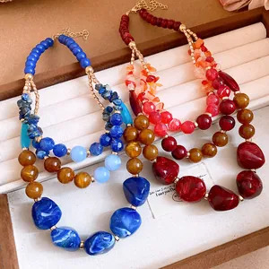 Macro view showing the texture of glossy agate stones and resin beads on the multi-layer necklace.