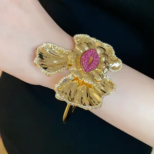 Close-up detail of vintage gold ruffled flower cuff bracelet with pink pavé rhinestones