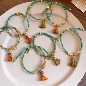 Close-up detail of hand-woven colorful cord bracelets with vibrant silk tassels