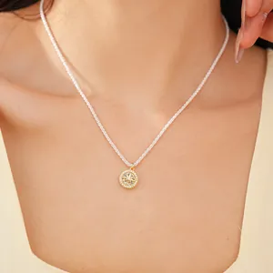 Detailed macro view of the gold eight-pointed star pendant set with brilliant zircons