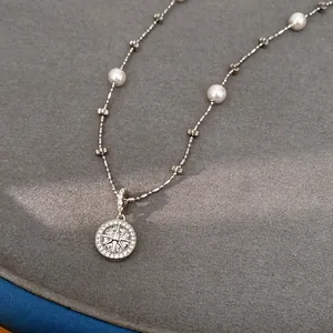 Macro view of silver eight-pointed star zircon pendant necklace with elegant pearls