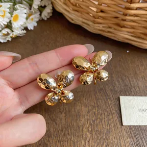 Macro view showing the hammered gold texture of these elegant butterfly earrings