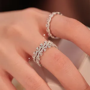 Close-up of elegant minimalist zircon lace rings on a hand for a luxury look.