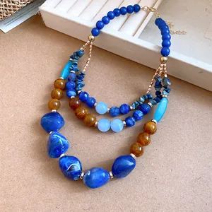 Detailed view of bohemian multi-layer necklace with blue agate and resin beads
