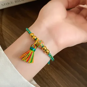 Handmade braided multi-colored rope bracelet with four-leaf clover and colorful tassel
