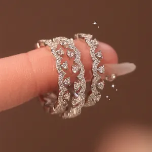 Close-up macro view of silver wavy lace ring set with sparkling cubic zirconia stones