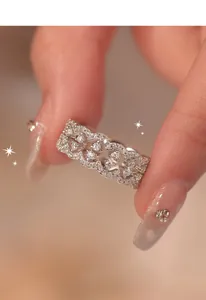Detailed close-up showing an elegant silver lace ring encrusted with sparkling zirconia stones