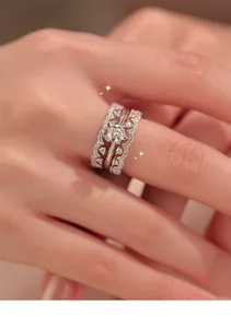 Close-up of zircon lace tiered ring set on female index finger with light luxury style.