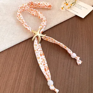 Romantic sea-inspired starfish shell bead scarf necklace for summer beach vacation style.
