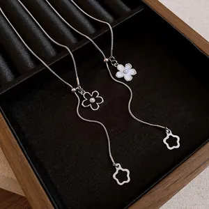 Detailed view of elegant adjustable necklaces with black and white flower pendants
