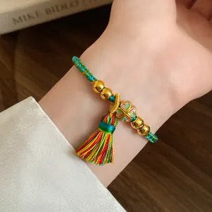 Close-up detail of handmade woven five-color thread bracelet with colorful tassel