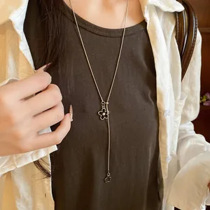 Close-up of a delicate Y-shaped pull-adjust necklace with pearl flower pendants
