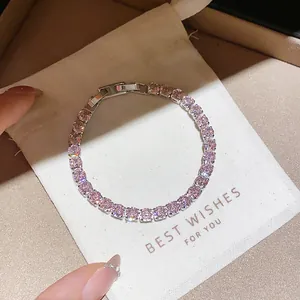 Elegant silver-toned tennis bracelet featuring sparkling pink zirconia on a soft pouch