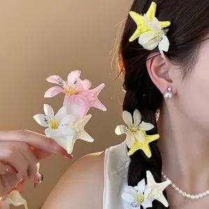 Elegant summer vacation style starfish and flower hair clips shown on model's hair