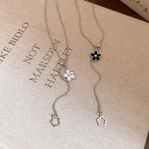 Detail view of the pearl flower pendant and pull-style necklace mechanism.