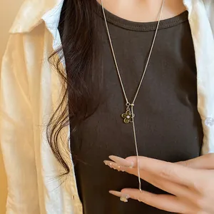 Elegant silver-tone adjustable necklace with floral pendant detail on model.