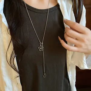 Close-up of a stylish acetate flower pendant lariat necklace with pearl on a model