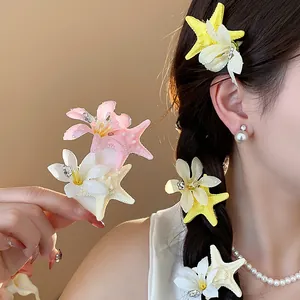 Detailed view of colorful starfish and flower hair clips worn in a braided hairstyle.