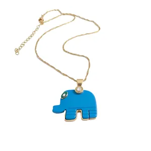 Elegant gold-tone clavicle chain with a bright blue elephant pendant featuring small crystals.