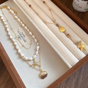 Gold-plated layered necklace set with natural conch shells and starfish pendants
