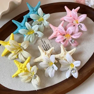 Detailed view of colorful starfish and flower hair clips with faux water droplets