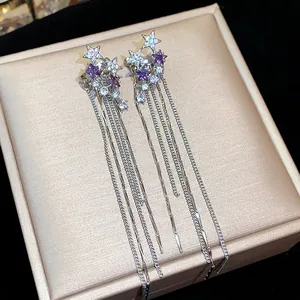 Detailed view of silver star tassel ear clips with purple zircon and sparkling stones
