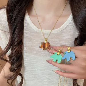 Detailed view of colorful resin elephant pendant necklaces featuring delicate gold chains.