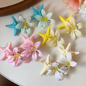 Detailed macro shot of colorful starfish flower hair clips featuring elegant rhinestone accents