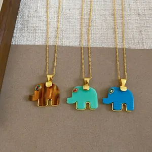 Detail of three colorful resin elephant pendants on fine gold-tone chain necklaces