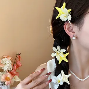 Detailed view of elegant starfish and flower hair clips styled on braided hair for beach look