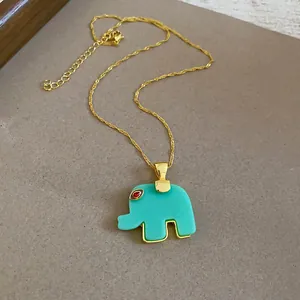 Close-up of a mint green resin elephant pendant necklace with a gold-colored chain.