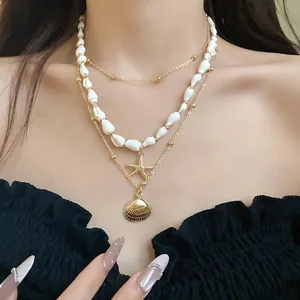 Detail of layered seashell and starfish pendant necklace for a bohemian vacation look