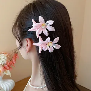 Detailed view of pink starfish flower hair clips elegantly worn on long dark hair accessory