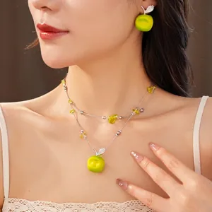 Elegant double-layered necklace with green resin apple pendant and matching stud earrings