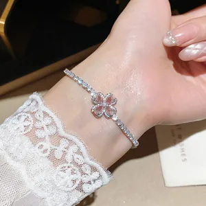 Close-up of pink zircon flower bracelet with sparkling silver chain on wrist
