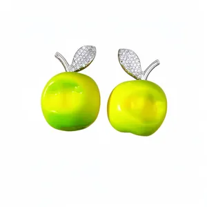 Elegant green resin apple earrings with sparkling zircon leaves on white backdrop