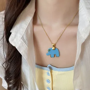 Close-up of blue resin elephant pendant necklace with green rhinestone eye decoration