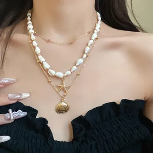 Close-up of 3-layer gold necklace with conch shells, starfish and shell pendants