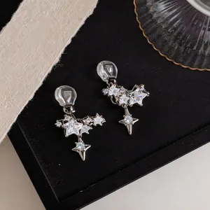 Close-up of sparkling star zircon ear clips with silver finish for non-pierced ears