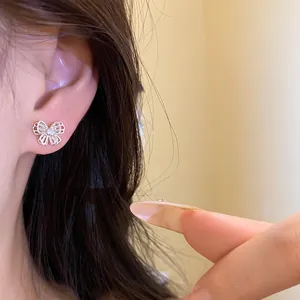 Detailed close-up of a delicate silver hollow butterfly stud earring with CZ accents.