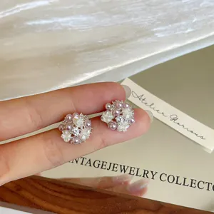 Elegant floral stud earrings featuring pearls and zircons for a sophisticated look