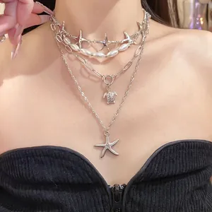 Elegant layered silver necklace with pearls, starfish and turtle pendants for a resort look.